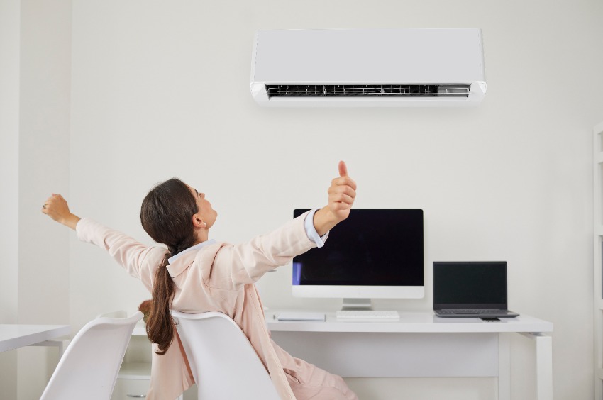 woman enjoying ductless heating and cooling systems